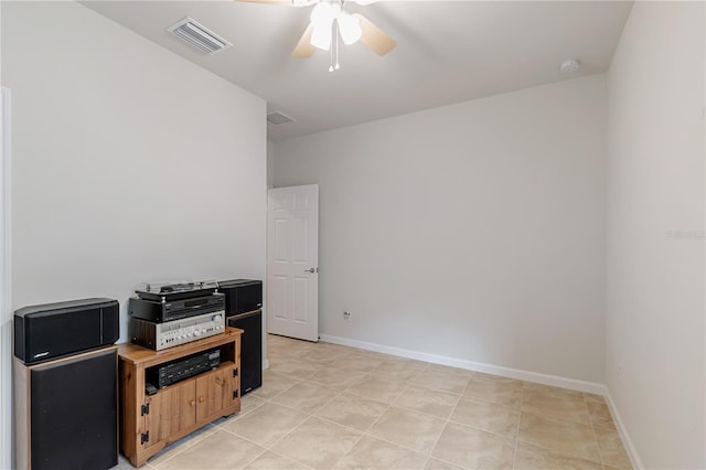 tiled spare room with ceiling fan