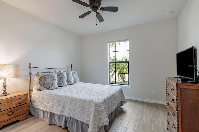 bedroom with ceiling fan and light wood-type flooring