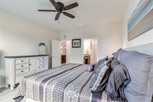 bedroom with ceiling fan, light hardwood / wood-style floors, and ensuite bath