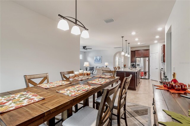 tiled dining room with ceiling fan