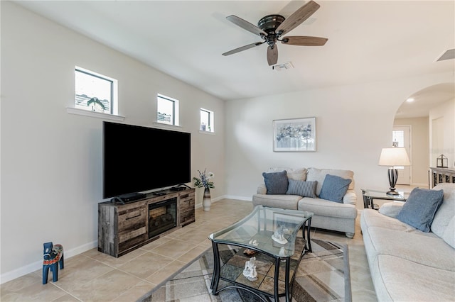 living room featuring light tile patterned floors, a wealth of natural light, and ceiling fan