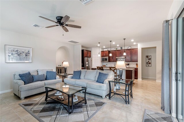 living room with ceiling fan and light tile patterned floors