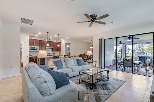 tiled living room with ceiling fan