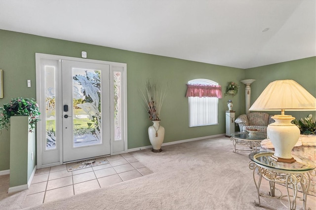 foyer with light colored carpet and a healthy amount of sunlight