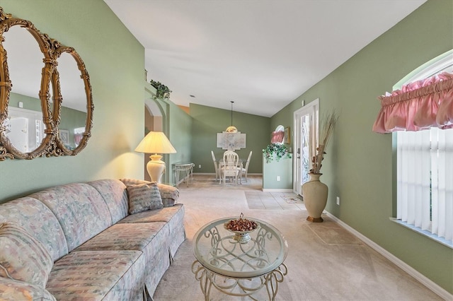 living room with light carpet and vaulted ceiling