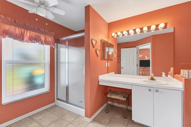 bathroom with ceiling fan, a shower with door, and tile patterned flooring