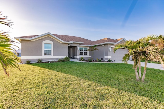 ranch-style home featuring a garage and a front yard