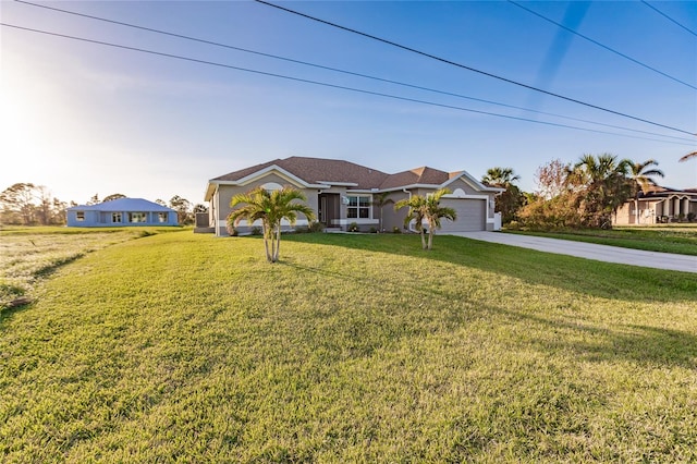 ranch-style house with a garage and a front yard