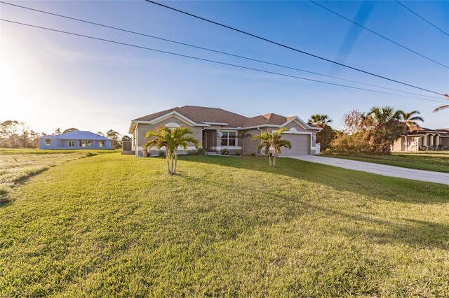 view of front of property featuring a garage and a front lawn