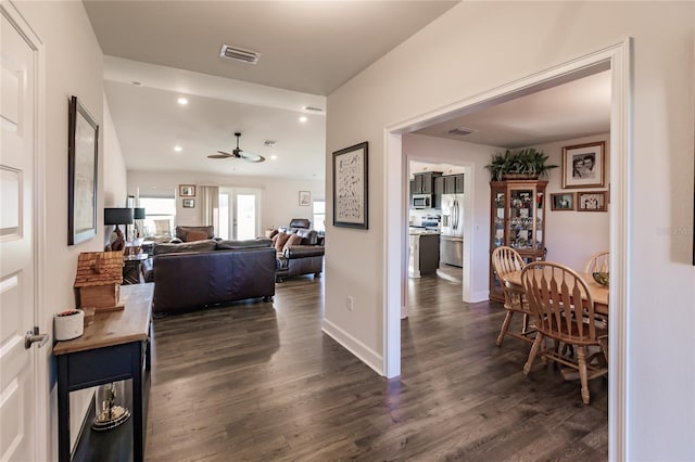 corridor with dark hardwood / wood-style flooring