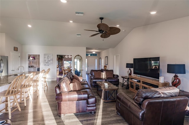 living room with high vaulted ceiling, wood-type flooring, sink, and ceiling fan