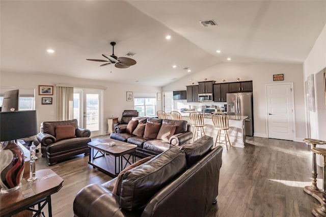 living room with dark wood-type flooring, lofted ceiling, french doors, and ceiling fan