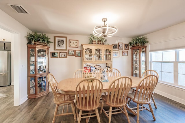 dining space featuring a chandelier and dark hardwood / wood-style flooring