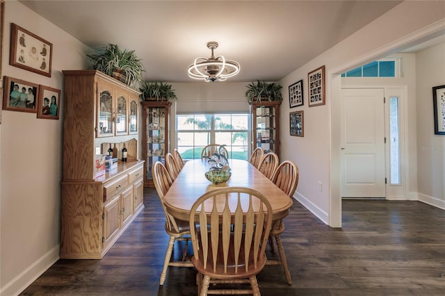 dining room with a chandelier and dark hardwood / wood-style floors