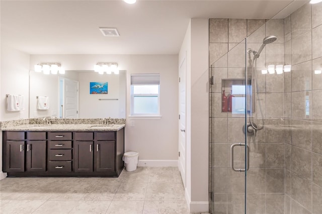 bathroom featuring vanity, tile patterned flooring, and a shower with shower door