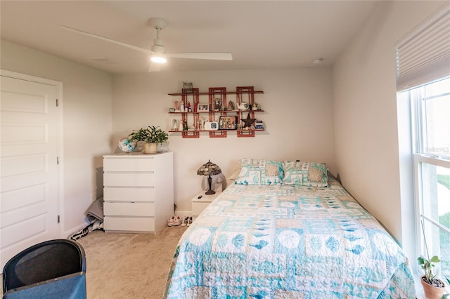 bedroom featuring light carpet and ceiling fan