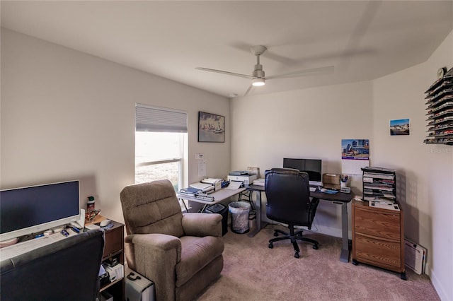 carpeted home office featuring ceiling fan