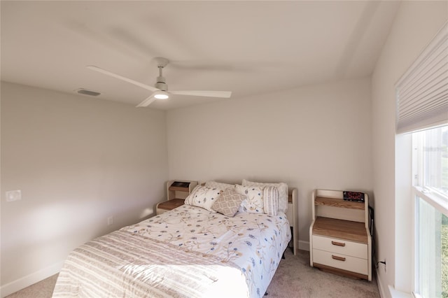 bedroom with ceiling fan and light colored carpet