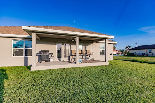 back of house with ceiling fan, a yard, and a patio