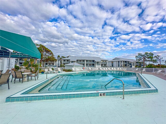 view of swimming pool with a patio