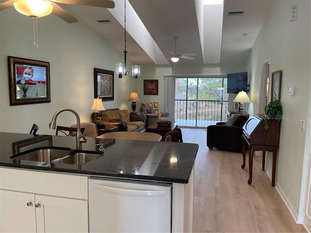 kitchen featuring white cabinetry, sink, white dishwasher, and dark stone counters