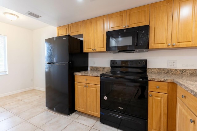 kitchen featuring light tile patterned flooring and black appliances