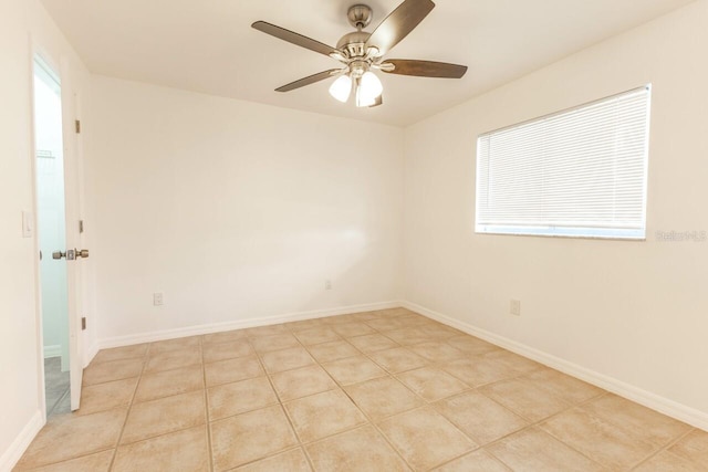 unfurnished room with ceiling fan and light tile patterned flooring