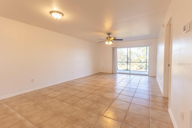 tiled empty room featuring ceiling fan