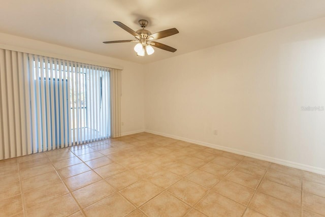 tiled empty room featuring ceiling fan