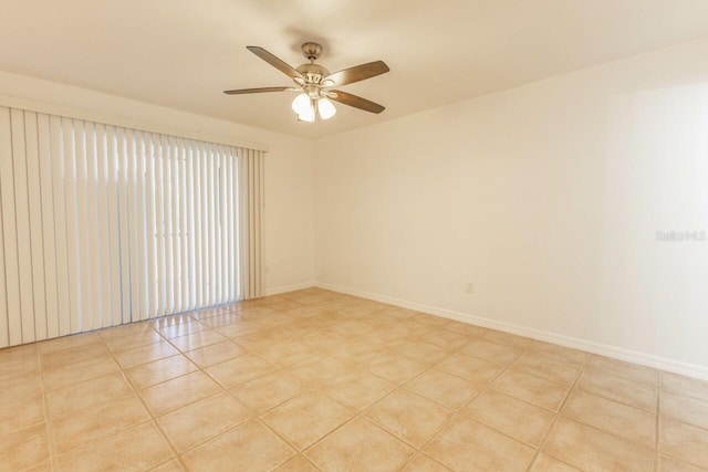 tiled empty room featuring ceiling fan