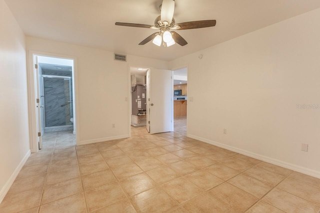 tiled empty room with ceiling fan