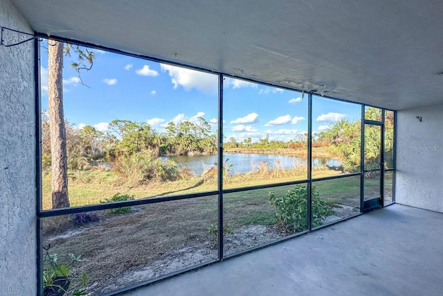 unfurnished sunroom with a water view