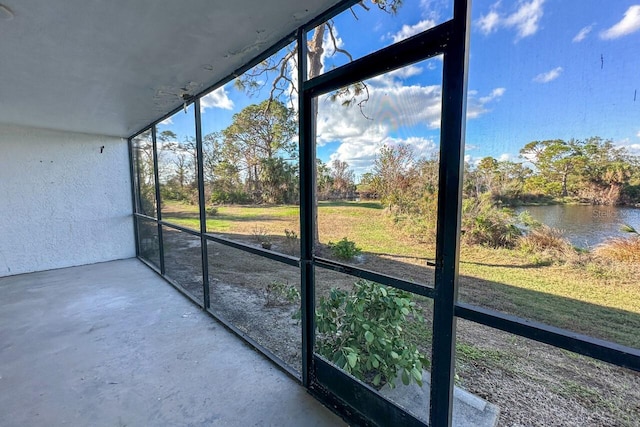 unfurnished sunroom with a water view