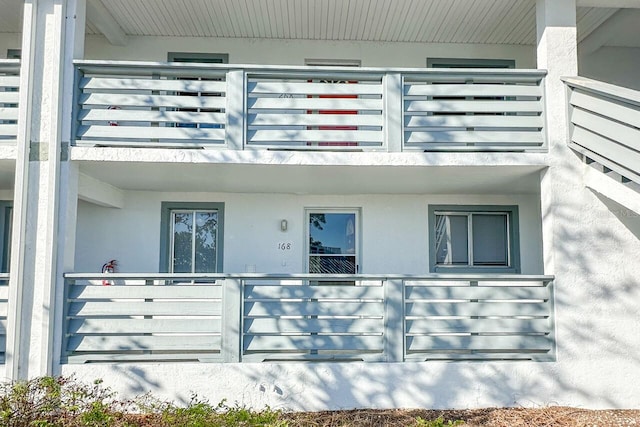 view of exterior entry featuring a balcony