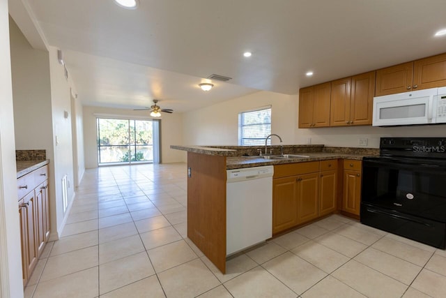 kitchen with white appliances, sink, ceiling fan, light tile patterned floors, and kitchen peninsula