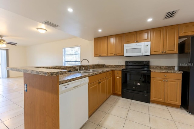 kitchen with kitchen peninsula, sink, light tile patterned flooring, and black appliances