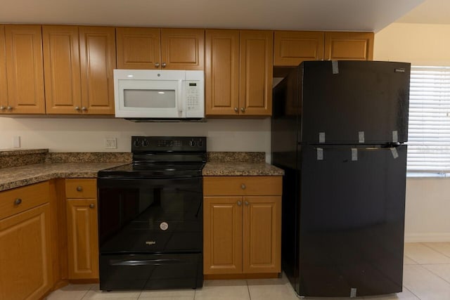 kitchen featuring light tile patterned floors and black appliances