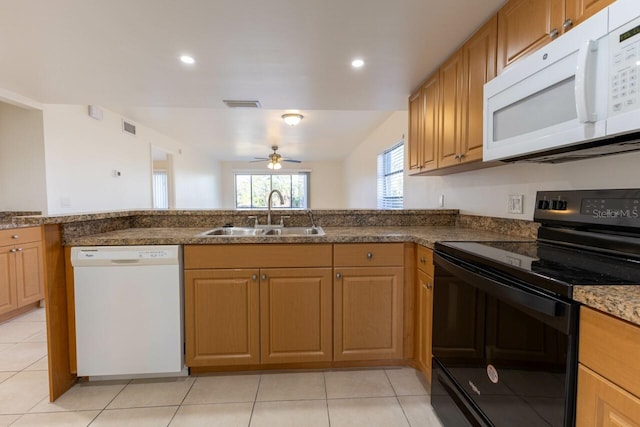 kitchen featuring stone counters, ceiling fan, sink, white appliances, and light tile patterned flooring