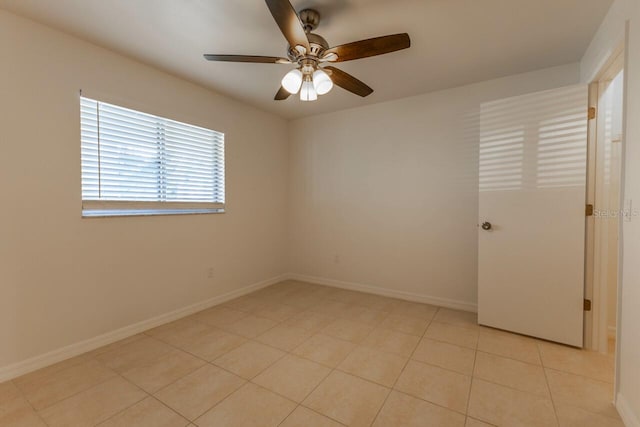 tiled empty room featuring ceiling fan