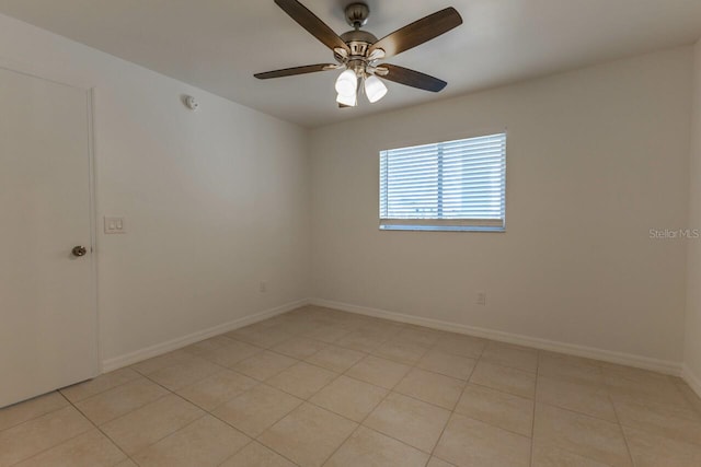 tiled empty room featuring ceiling fan