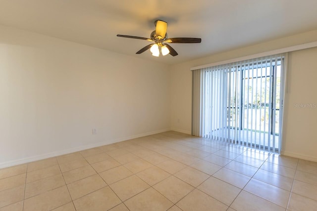 tiled spare room featuring ceiling fan