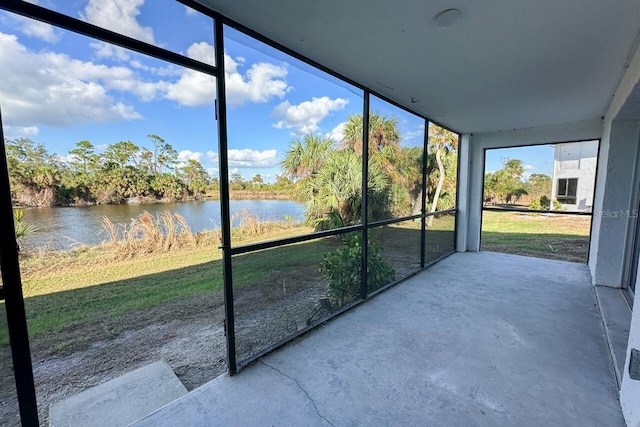 unfurnished sunroom with a water view