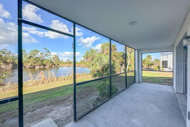 unfurnished sunroom with a water view