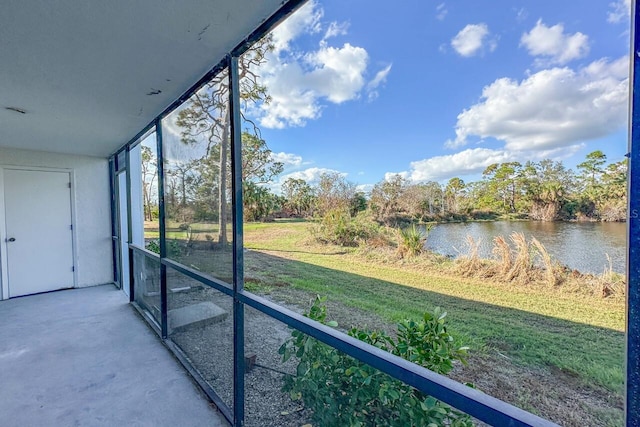 unfurnished sunroom with a water view