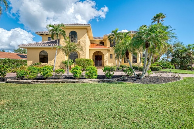 mediterranean / spanish-style home featuring a front lawn