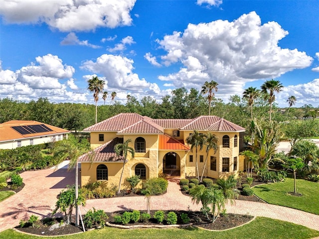 mediterranean / spanish-style house with a front lawn