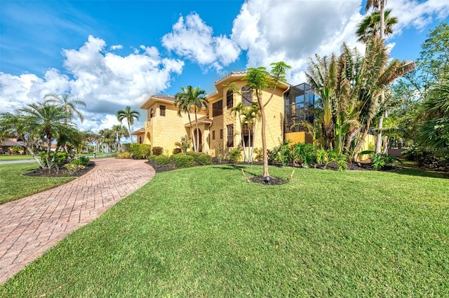 mediterranean / spanish-style home with a front yard