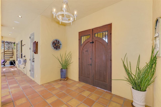 entryway with tile patterned floors and a chandelier