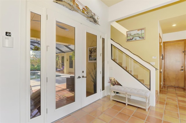 entryway with tile patterned flooring and french doors