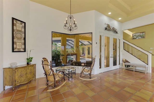 living area featuring french doors, tile patterned floors, and a high ceiling